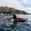 Old Town PDL Kayak with scuba diver pulling gear back on board 